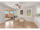 Dining area featuring tile floors, a sliding glass door, white chairs, and white shutters at 11139 Zarod Rd, Las Vegas, NV 89135
