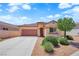 Charming single-story home featuring a desert landscape, a two car garage, and a tiled roof at 11139 Zarod Rd, Las Vegas, NV 89135