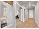 Inviting hallway featuring tile floors, arched doorways, and a view into the bedrooms at 11139 Zarod Rd, Las Vegas, NV 89135