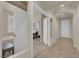 Inviting hallway showcasing the transition between rooms, with neutral tones and tile flooring at 11139 Zarod Rd, Las Vegas, NV 89135