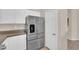 Kitchen featuring stainless steel refrigerator, white cabinets, and pantry at 11139 Zarod Rd, Las Vegas, NV 89135