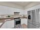 Bright kitchen with stainless steel appliances, gas range, and white cabinetry at 11139 Zarod Rd, Las Vegas, NV 89135