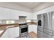 Well-lit kitchen featuring stainless steel appliances and white cabinets providing a clean, modern look at 11139 Zarod Rd, Las Vegas, NV 89135
