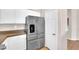 Modern kitchen featuring stainless steel appliances, white cabinets, and tan countertops at 11139 Zarod Rd, Las Vegas, NV 89135