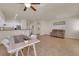 An open-concept living room and kitchen layout enhanced by tile floors and natural light at 11139 Zarod Rd, Las Vegas, NV 89135