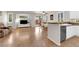 Open-concept living space featuring tile floors, white cabinetry, stainless steel appliances, and modern decor at 11139 Zarod Rd, Las Vegas, NV 89135
