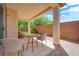 Charming covered patio with a cozy seating area perfect for outdoor entertaining at 11139 Zarod Rd, Las Vegas, NV 89135