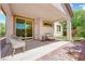 Relaxing covered patio area with stylish outdoor furniture and well-maintained landscaping at 11139 Zarod Rd, Las Vegas, NV 89135