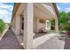 Charming covered patio with string lights, outdoor seating, and a well-maintained yard at 11139 Zarod Rd, Las Vegas, NV 89135