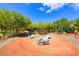 Community playground featuring animal statues, play equipment, and mature trees under a blue sky at 11139 Zarod Rd, Las Vegas, NV 89135