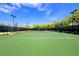 Well-maintained community tennis court surrounded by lush greenery and mature trees at 11139 Zarod Rd, Las Vegas, NV 89135