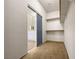 Spacious walk-in closet with carpet and closet system, and a view to the bathroom at 11139 Zarod Rd, Las Vegas, NV 89135