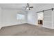 Spacious bedroom with ceiling fan, closet with barn door, and a window at 124 Wynntry Dr, Henderson, NV 89074