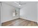 Bright bedroom features a ceiling fan, light wood floors, and large window at 124 Wynntry Dr, Henderson, NV 89074