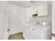 Bright laundry room with cabinetry, tile floor, and updated washer and dryer at 124 Wynntry Dr, Henderson, NV 89074