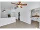 Open concept living room with tile flooring, high ceilings, ceiling fan, and staircase to the second floor at 124 Wynntry Dr, Henderson, NV 89074