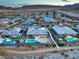An expansive aerial view captures a residential neighborhood with a variety of modern homes, pools, and desert landscaping at 12544 Claymore Highland Ave, Las Vegas, NV 89138