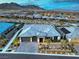 A stunning aerial view of a modern home featuring desert landscaping, a paved driveway, and manicured outdoor spaces at 12544 Claymore Highland Ave, Las Vegas, NV 89138