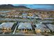 A panoramic view showcases a community of modern homes, each with a pool and distinct desert landscaping, set against mountains at 12544 Claymore Highland Ave, Las Vegas, NV 89138