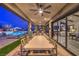 Backyard featuring an expansive covered patio and a beautiful outdoor pool area at 12544 Claymore Highland Ave, Las Vegas, NV 89138