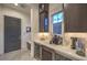 Home bar area with beverage cooler, custom cabinetry, and stylish countertop, perfect for entertaining at 12544 Claymore Highland Ave, Las Vegas, NV 89138