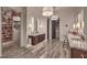 A luxurious bathroom featuring double vanities, stone floors, and a walk-in closet with custom shelving for shoes and handbags at 12544 Claymore Highland Ave, Las Vegas, NV 89138
