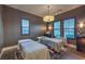 Relaxing spa room featuring a massage table, pendant lighting, and louvered windows at 12544 Claymore Highland Ave, Las Vegas, NV 89138