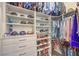 An organized walk-in closet with custom shelving for shoes, clothes, hats, and other accessories at 12544 Claymore Highland Ave, Las Vegas, NV 89138