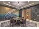 Stylish dining room featuring custom wallpaper, modern chandelier, and a full wine cabinet at 12544 Claymore Highland Ave, Las Vegas, NV 89138