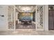 Elegant dining room with modern chandelier, designer wallpaper, and wine cabinet at 12544 Claymore Highland Ave, Las Vegas, NV 89138