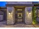 Beautiful courtyard featuring stone columns, and a decorative gate leading to the front door at 12544 Claymore Highland Ave, Las Vegas, NV 89138