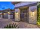 Stylish entrance with a gated courtyard, stone pillars, and desert landscaping at 12544 Claymore Highland Ave, Las Vegas, NV 89138