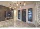 Elegant entryway featuring decorative lighting, cabinetry, and tile flooring at 12544 Claymore Highland Ave, Las Vegas, NV 89138