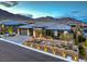Captivating exterior showcasing a modern design, desert landscaping, and neighborhood views at 12544 Claymore Highland Ave, Las Vegas, NV 89138