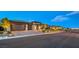 Attractive front exterior with a three car garage, stone accents, and desert landscaping at 12544 Claymore Highland Ave, Las Vegas, NV 89138