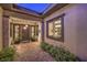 Inviting front entrance with brick pathway, stylish door, and lush landscaping creates curb appeal at 12544 Claymore Highland Ave, Las Vegas, NV 89138