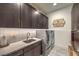 Well-equipped laundry room featuring front loading washer and dryer and custom cabinets at 12544 Claymore Highland Ave, Las Vegas, NV 89138