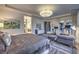 A spacious main bedroom with large bed, sitting area, and access to ensuite bathroom and well-equipped home gym at 12544 Claymore Highland Ave, Las Vegas, NV 89138