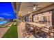 Covered patio with dining area offering views of the pool and backyard at 12544 Claymore Highland Ave, Las Vegas, NV 89138