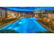 Inviting pool and spa is surrounded by desert landscaping and an outdoor eating area with lounge seating and mountain views at 12544 Claymore Highland Ave, Las Vegas, NV 89138