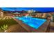 Inviting pool area with a modern pool, sleek patio, and lush landscaping at 12544 Claymore Highland Ave, Las Vegas, NV 89138