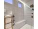 Close up of a luxurious shower with bronze shower head, white tile walls, and a built-in seat at 12544 Claymore Highland Ave, Las Vegas, NV 89138