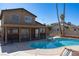 Backyard pool with clear blue water, surrounded by a concrete patio and palm trees, perfect for relaxation at 1340 Lucky St, Las Vegas, NV 89104