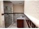 Bathroom featuring a glass-enclosed shower and granite-topped vanity with dark wood cabinets at 1340 Lucky St, Las Vegas, NV 89104