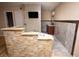 Relaxing bathroom featuring a jetted tub with stone surround and wall-mounted television at 1340 Lucky St, Las Vegas, NV 89104