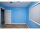 Bedroom features modern ceiling fan, wood-look floor and bright blue walls at 1340 Lucky St, Las Vegas, NV 89104