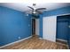 Bright bedroom featuring wood-look floors, ceiling fan, and closet at 1340 Lucky St, Las Vegas, NV 89104