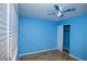 Bedroom featuring wood-look floors, bright blue walls, and closet space at 1340 Lucky St, Las Vegas, NV 89104