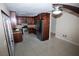 Well-appointed kitchen featuring stainless steel appliances, rich wooden cabinets, and stylish tile flooring, perfect for culinary enthusiasts at 1340 Lucky St, Las Vegas, NV 89104