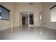 Bright and open living room with tile flooring, staircase, and windows, creating a spacious and inviting atmosphere at 1340 Lucky St, Las Vegas, NV 89104
